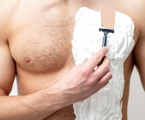 Young,Caucasian,Man,With,Beard,Holds,Razor,Shaves,His,Chest